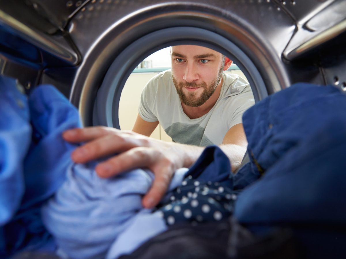Man removing clothing from washing machine