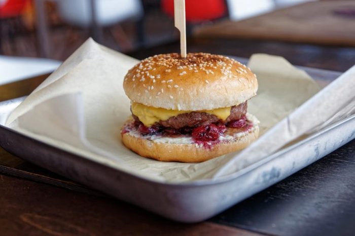 Burger with cherry and cheese in fast food restaurant