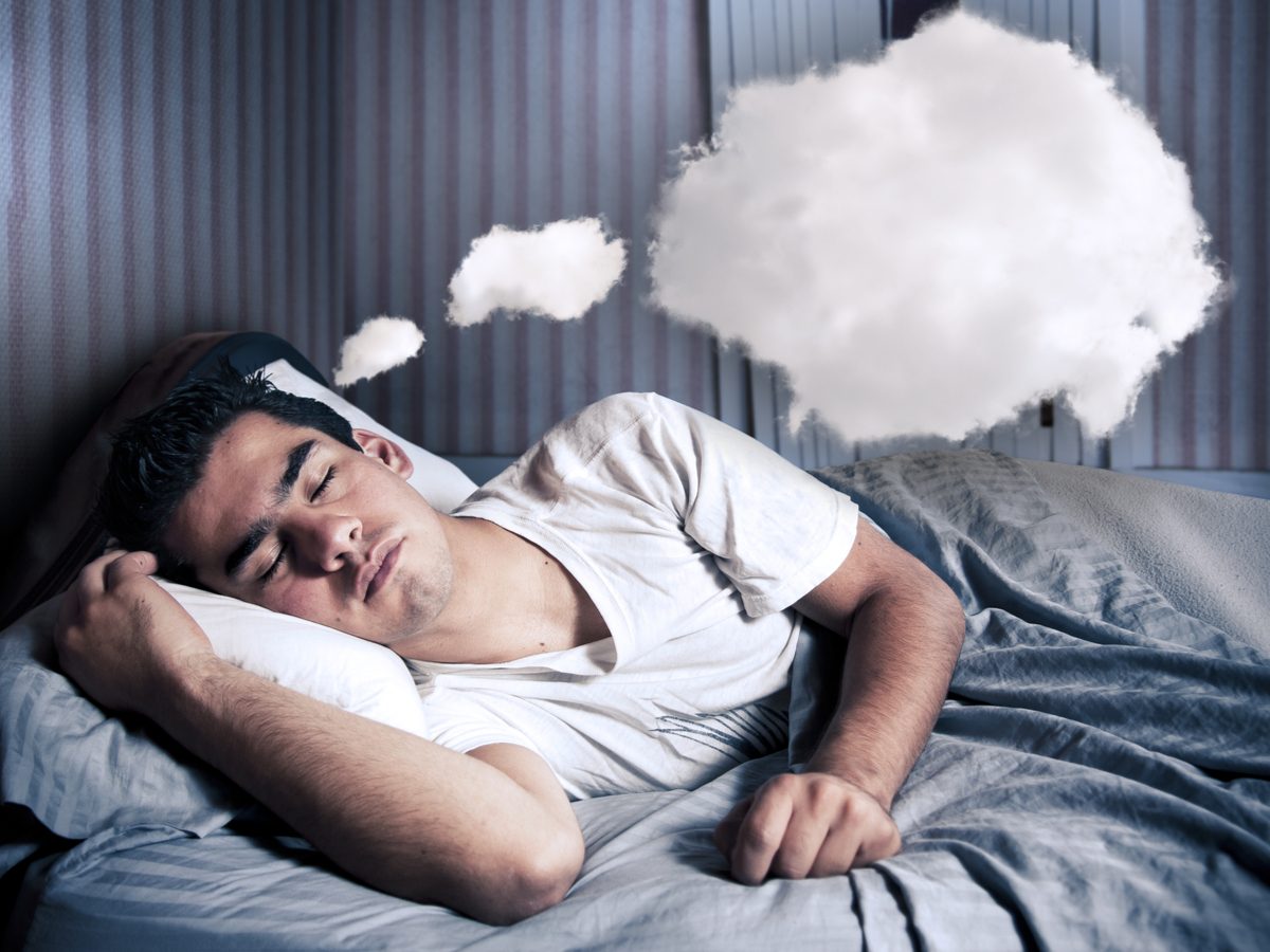 Man comfortably sleeping in his bed at night