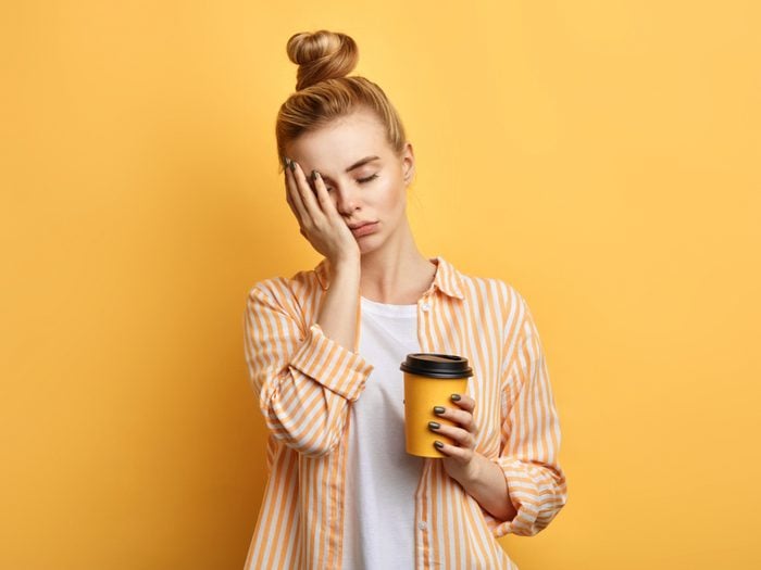 Sleep jokes - tired woman holding coffee