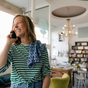 woman on smiling on the phone with a friend