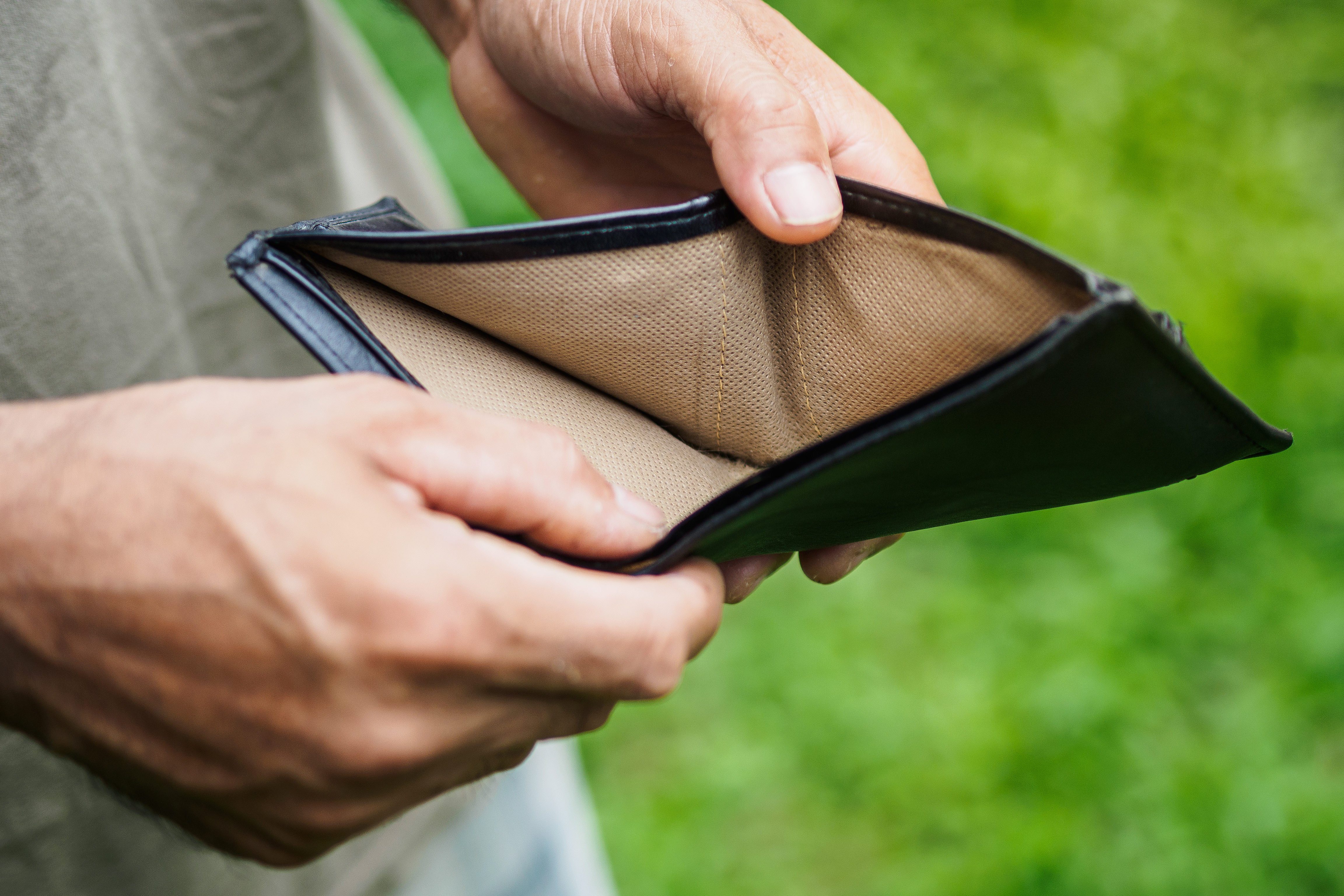 Midsection Of Man Holding Empty Wallet
