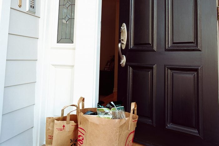 Bags of grocery in front of open door