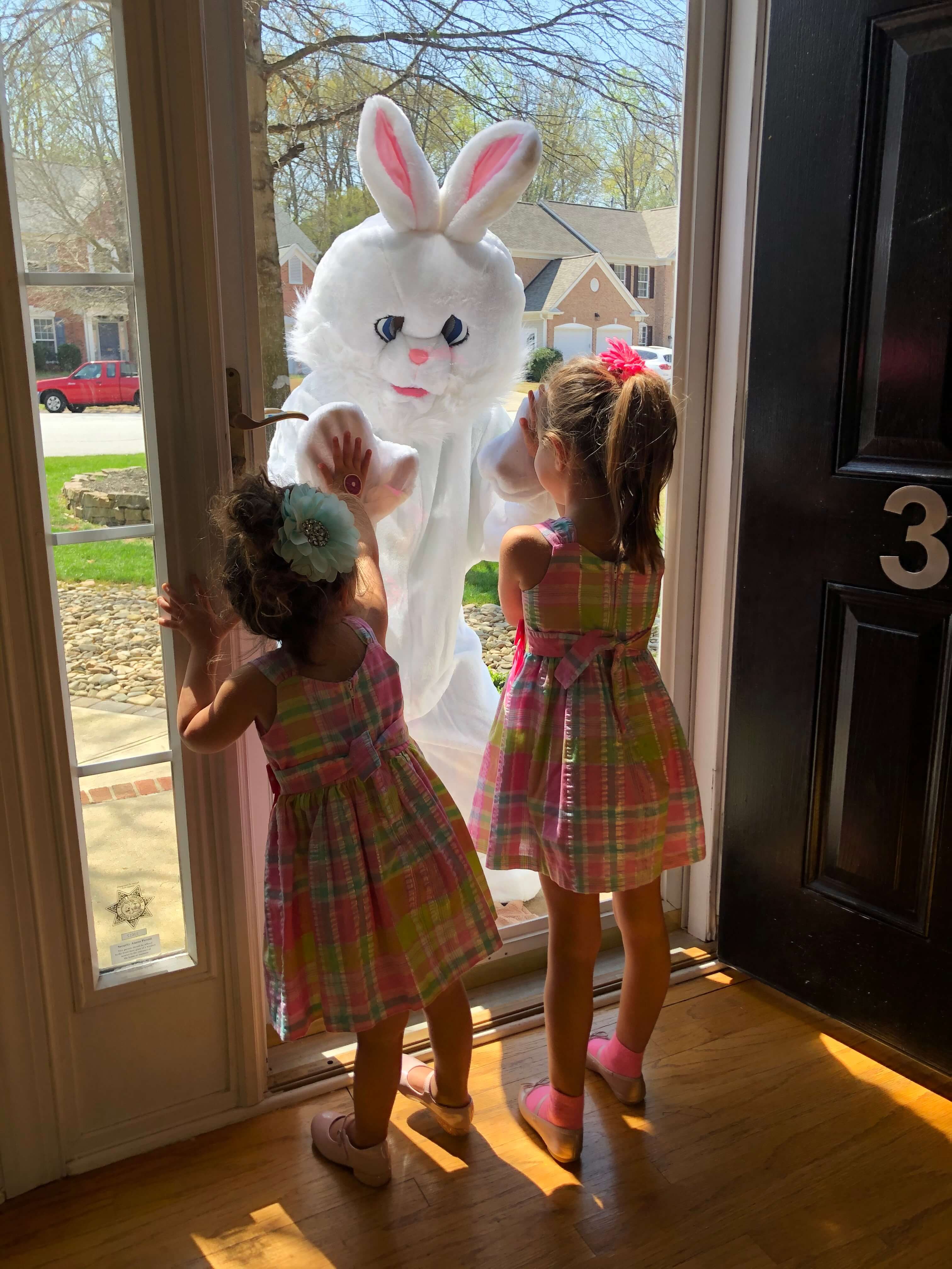 Easter bunny visiting two little girls at their home on Easter