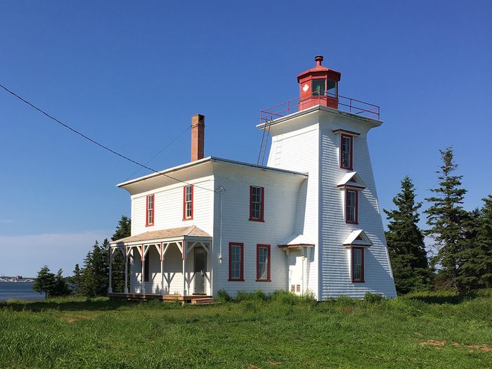 historical canadian photos - red and white lighthouse