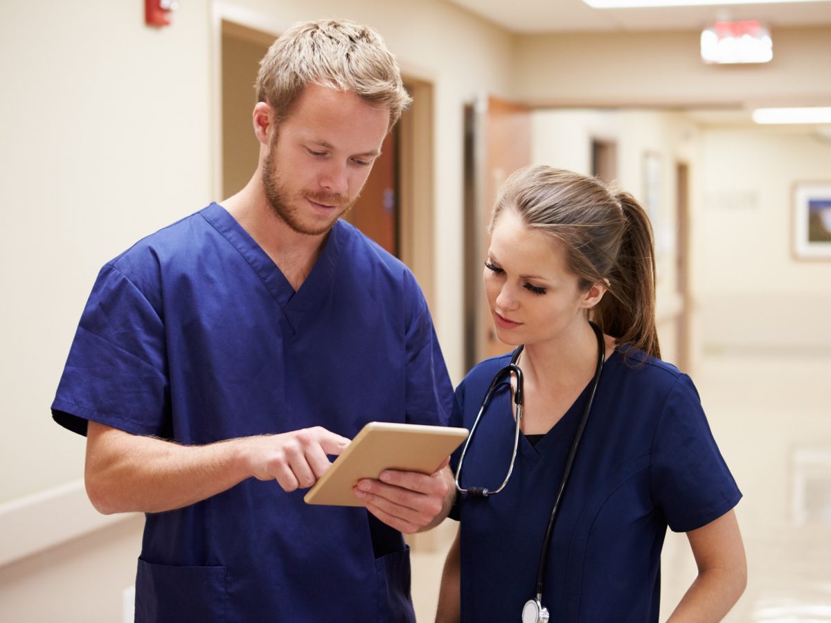 Male nurse speaking with his female colleague