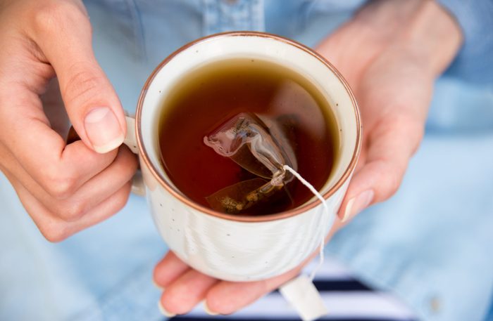 Home remedies for hemorrhoids - Woman Holding a Warm Cup of Freshly Brewed Tea