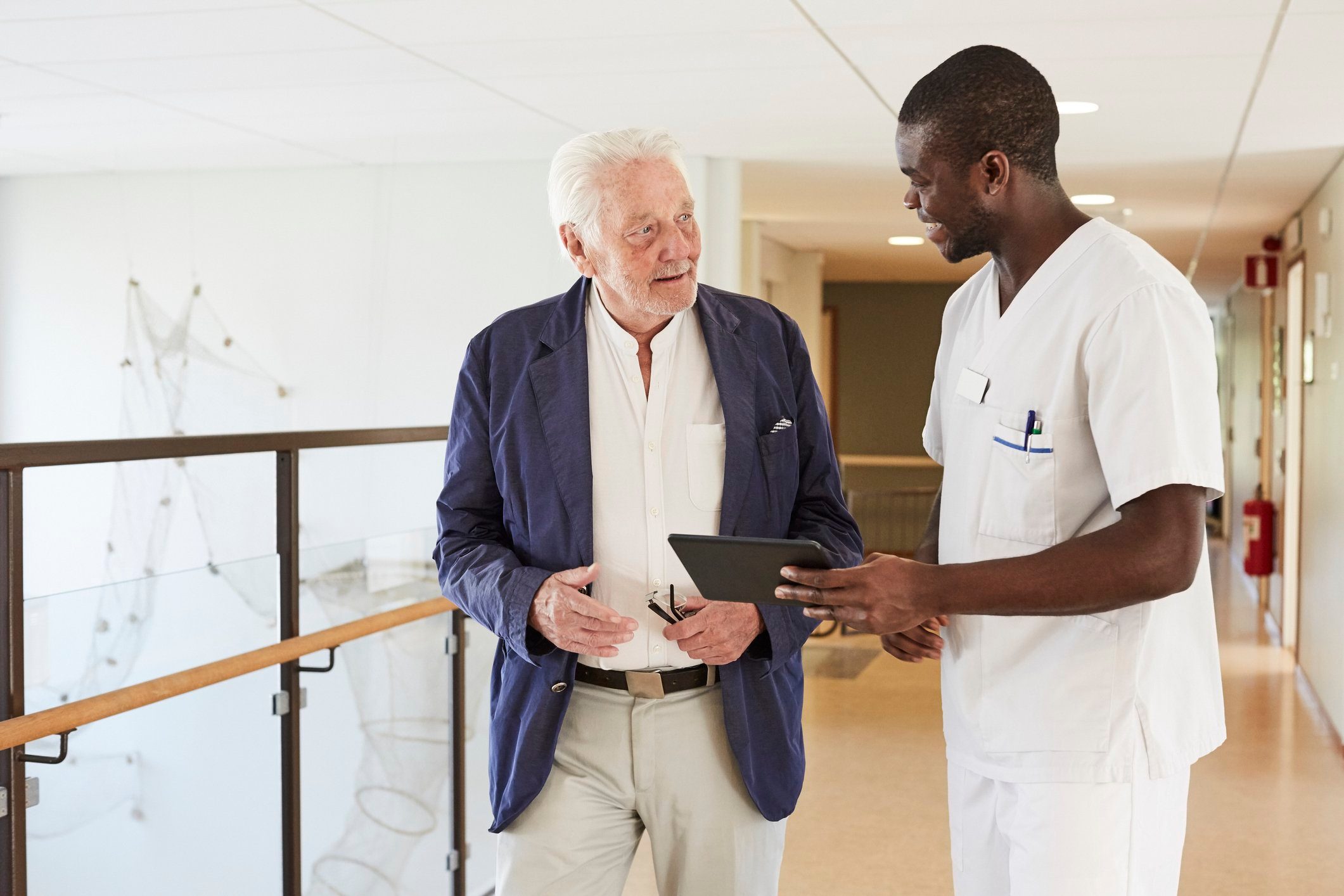 male nurse talking to senior male patient