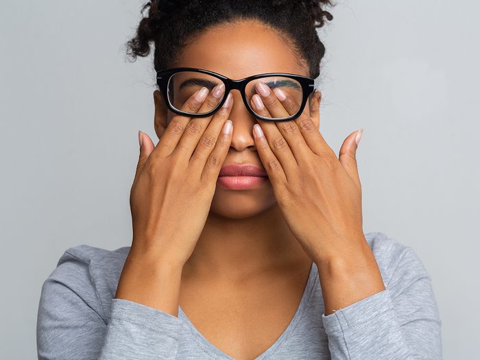 Allergies vs pinkeye - woman rubbing her eyes