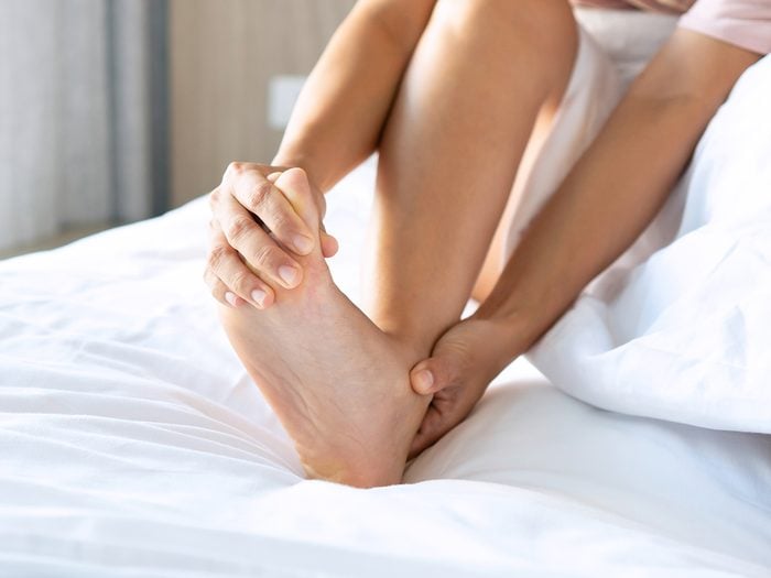 Sore feet remedies - woman rubbing foot