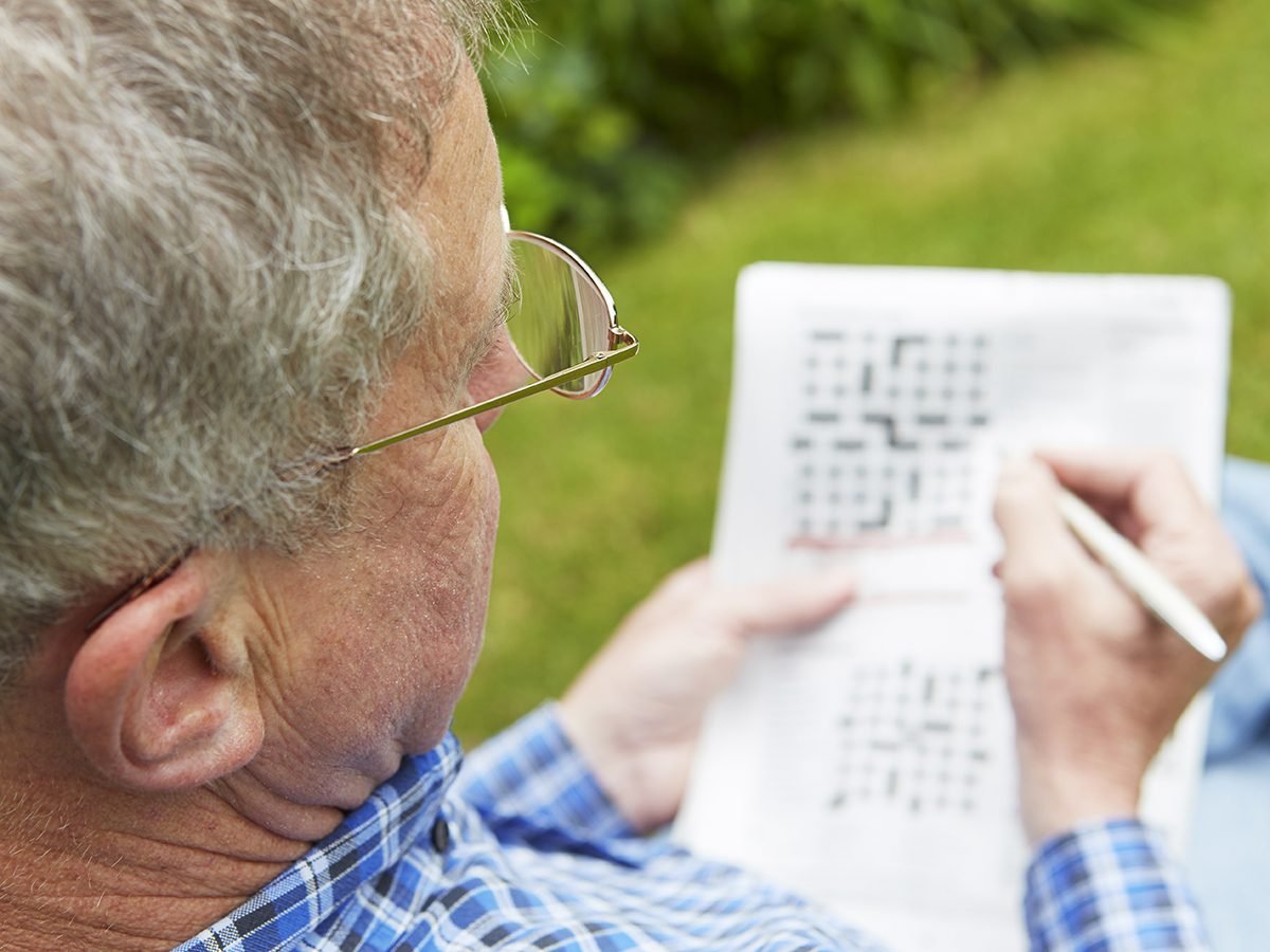 Things that slow down aging - senior man doing crossword