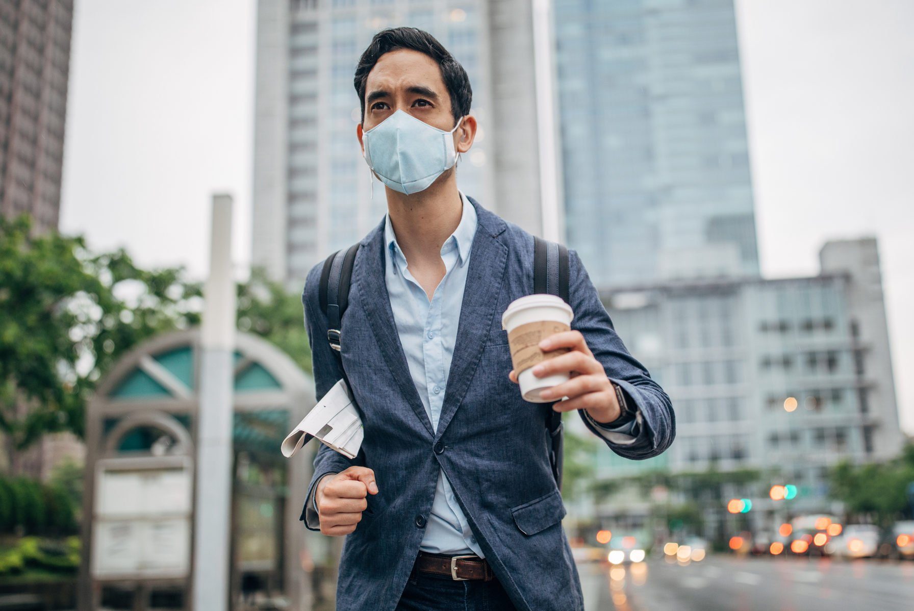 Gentleman with pollution mask in coronavirus infected city downtown