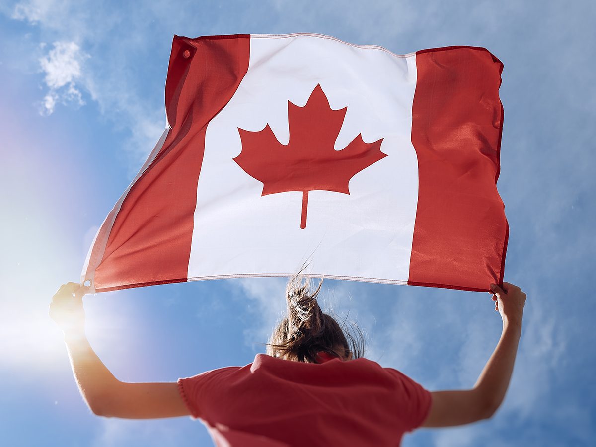 Canada Day activities - child waving Canada flag