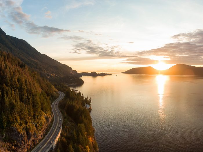 Canada road trip - Sea to Sky Hwy in Howe Sound near Horseshoe Bay, West Vancouver, British Columbia, Canada. Aerial panoramic view during a colorful sunset in Fall Season.