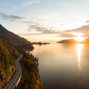 Road trip Canada - Sea to Sky Hwy in Howe Sound near Horseshoe Bay, West Vancouver, British Columbia, Canada. Aerial panoramic view during a colorful sunset in Fall Season.
