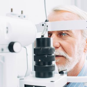 Health symptoms you should never ignore - senior man getting eye test at optometrist