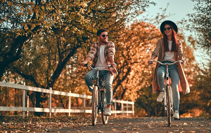 Sunglasses myths - Couple riding bicycle in fall