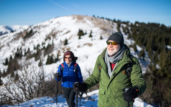 Sunglasses myth - Senior couple nordic walking in winter