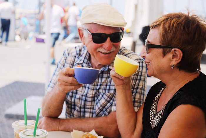Sunglasses myths - Senior couple drinking coffee outside