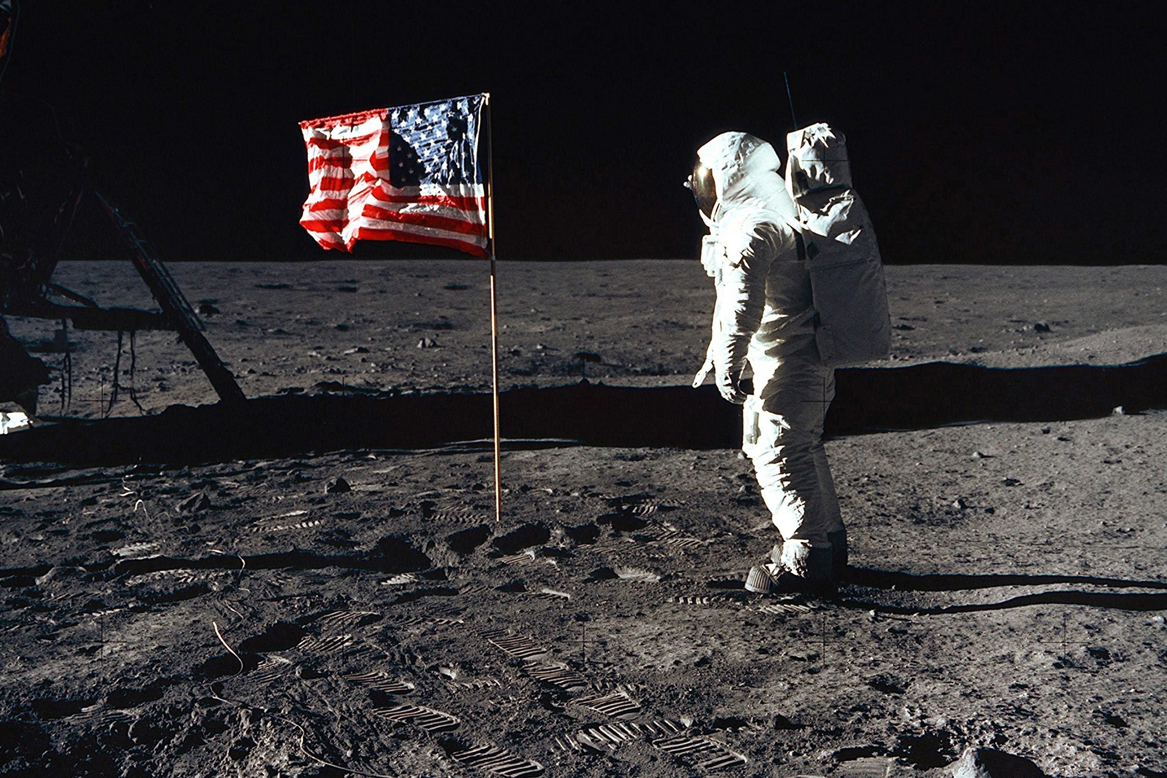 Astronaut Edwin 'Buzz' Aldrin, lunar module pilot of the first lunar landing mission, poses for a photograph beside the U.S. flag during the Apollo 11 mission