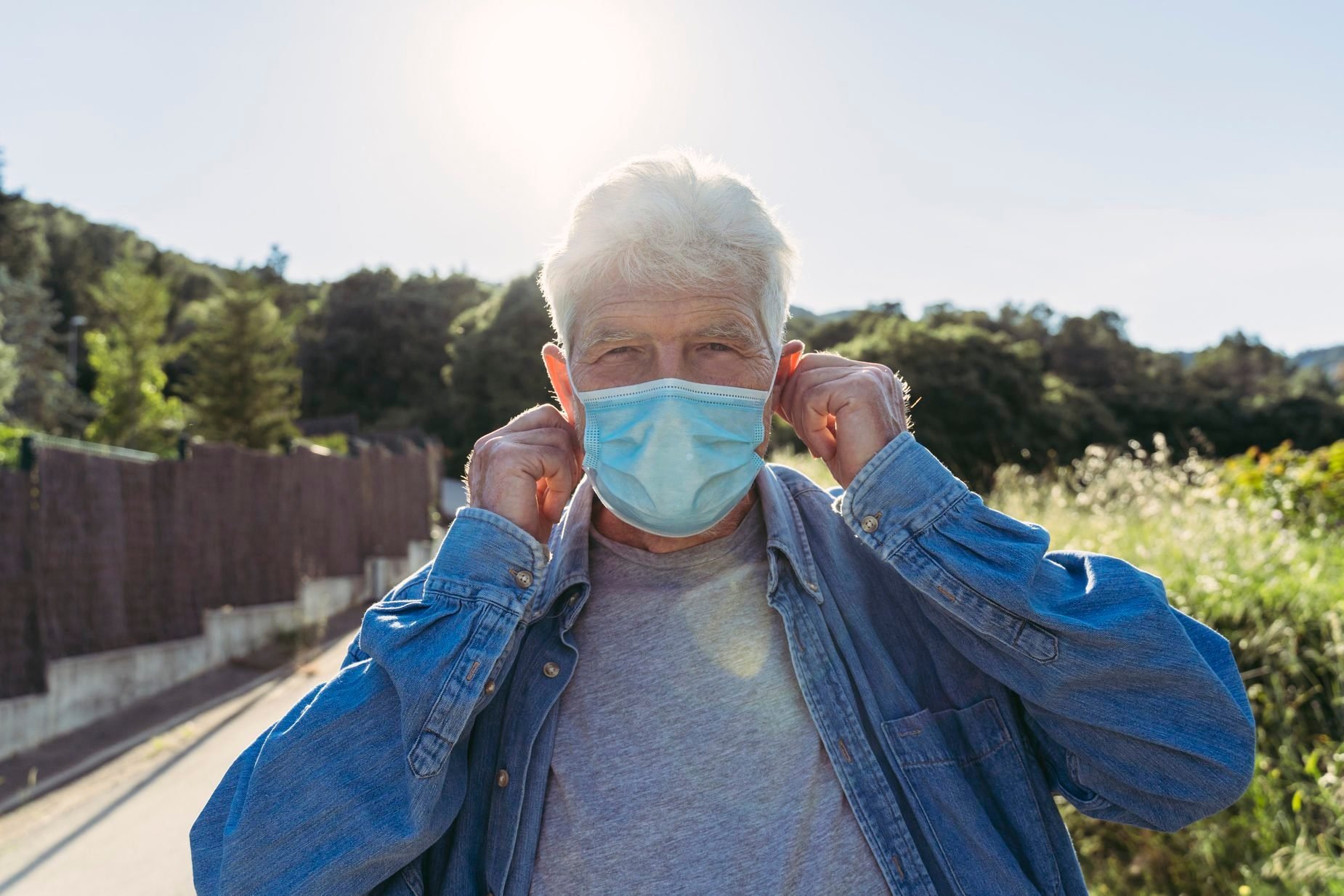 Senior man with protective mask outdoors