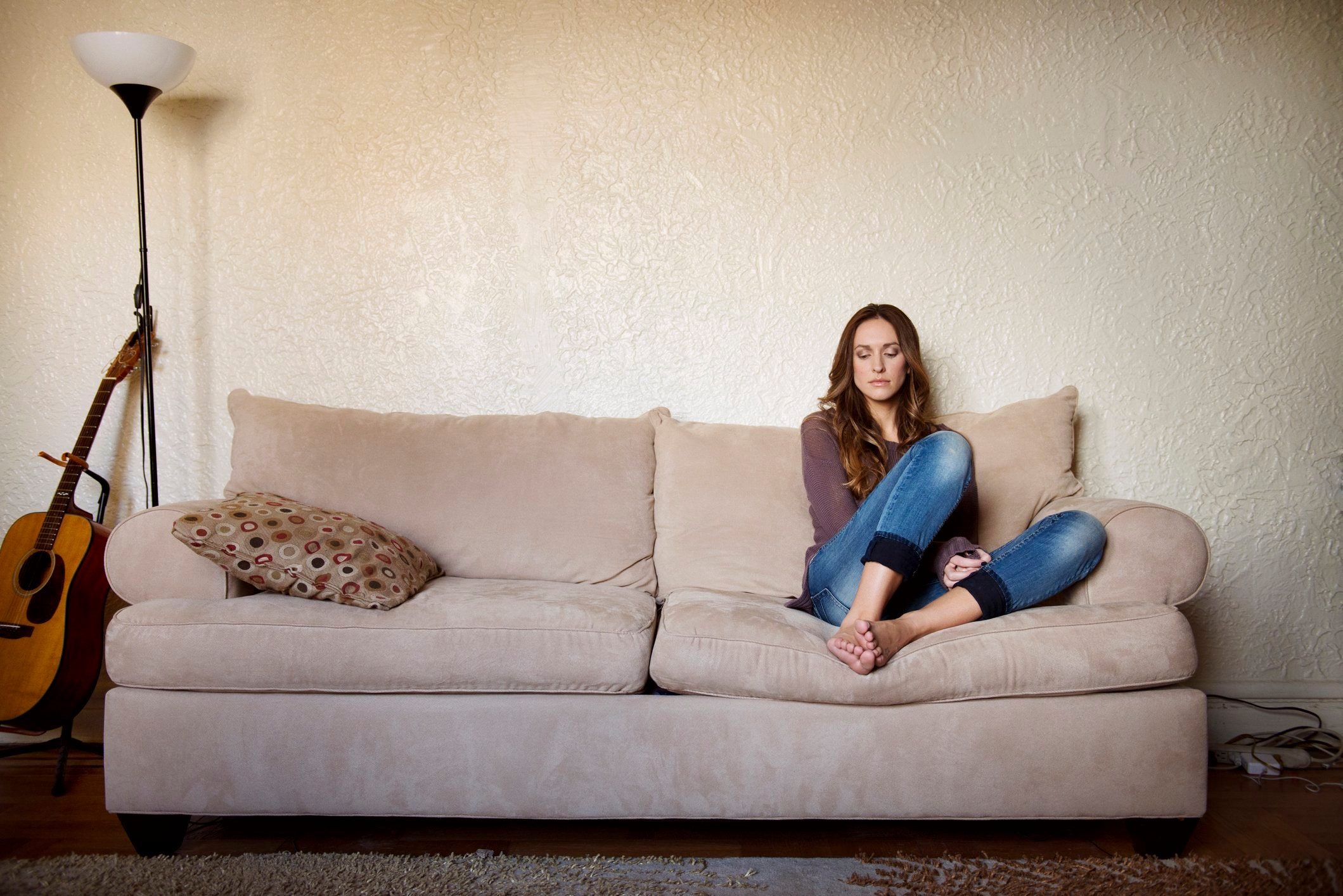 woman sitting on couch at home
