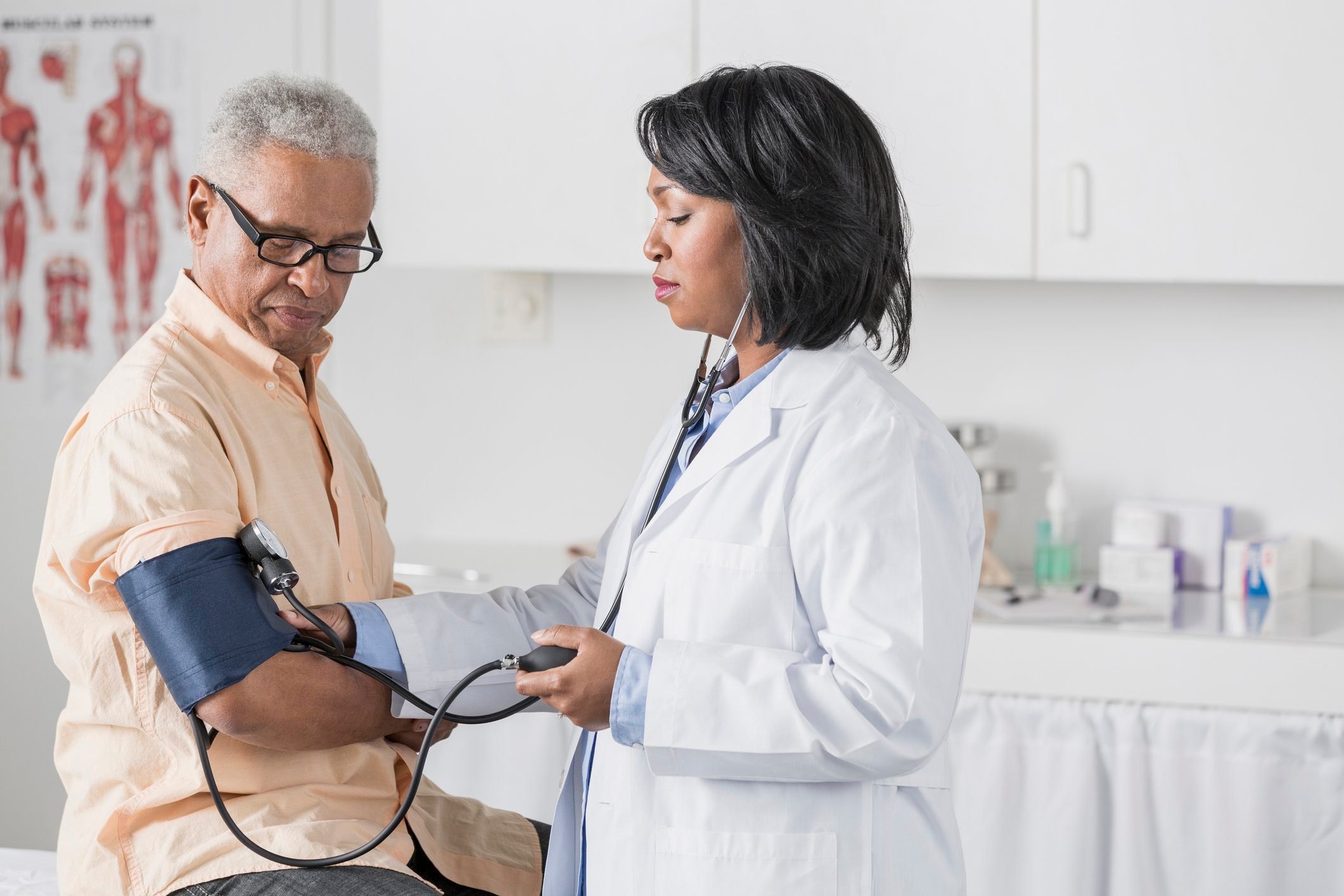 doctor checking man's blood pressure