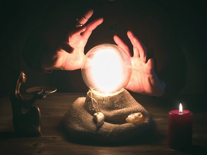 Cases solved by psychics - Crystal ball and fortune teller hands. Divination concept. The spiritual seance. Future reading.