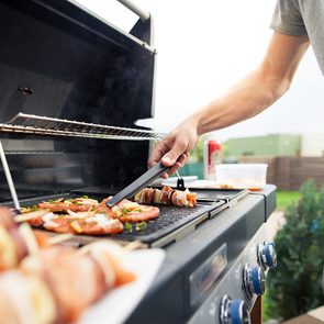 Grilling tips - man flipping food on BBQ