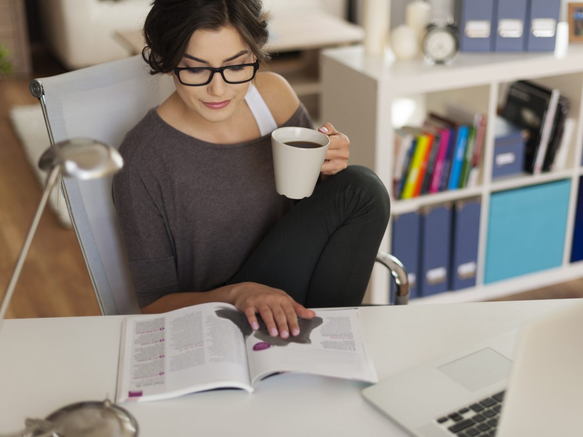 Woman drinking coffee in her home office