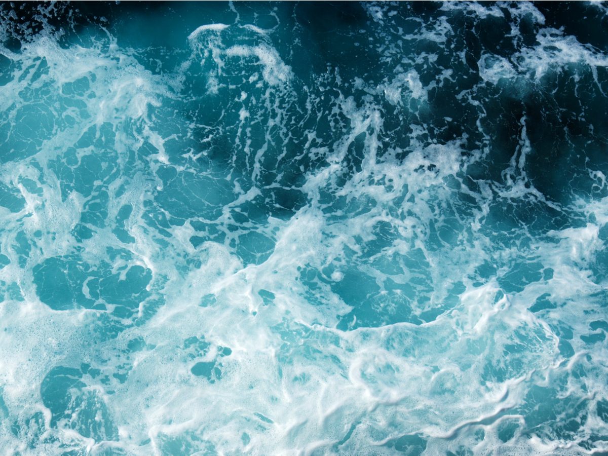 Abstract blue sea water with white wave