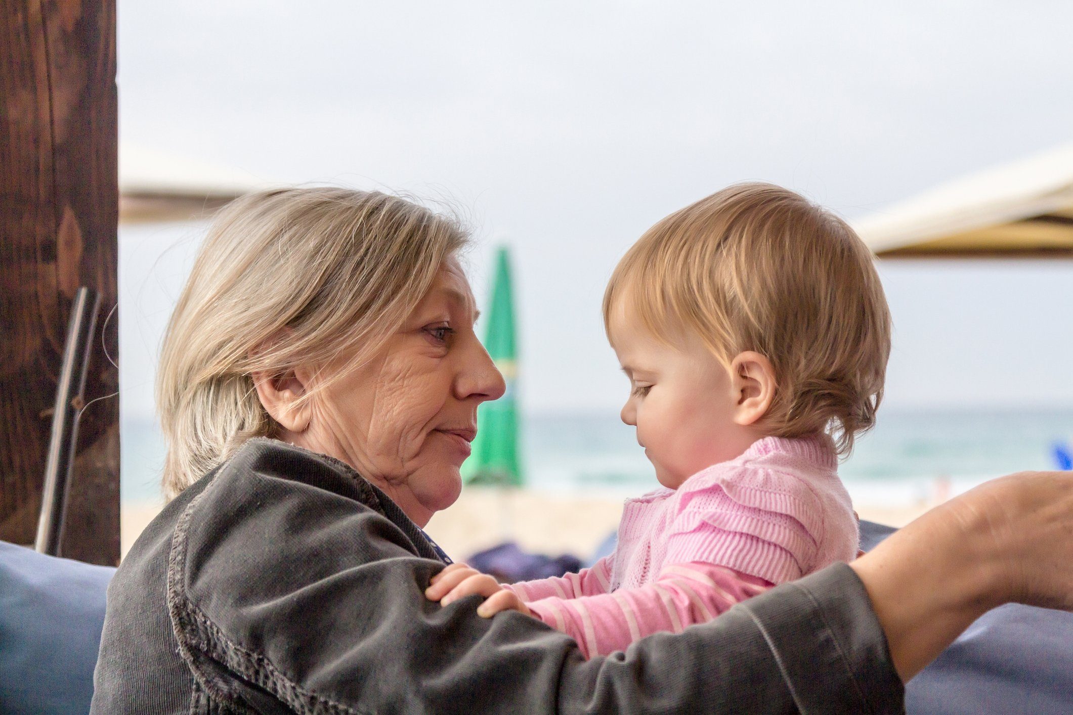 Grandmother holding and hugging her cute baby granddaughter