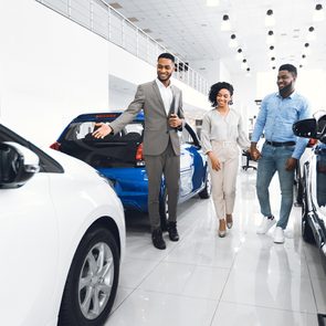 How much do dealers make on new cars - car dealer showing clients showroom