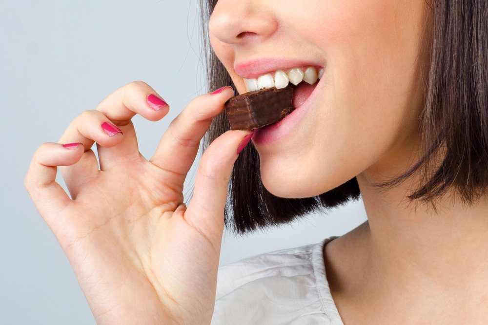 woman eating chocolate brownie