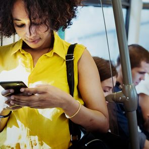 Text slang - Young woman using a smartphone in a subway