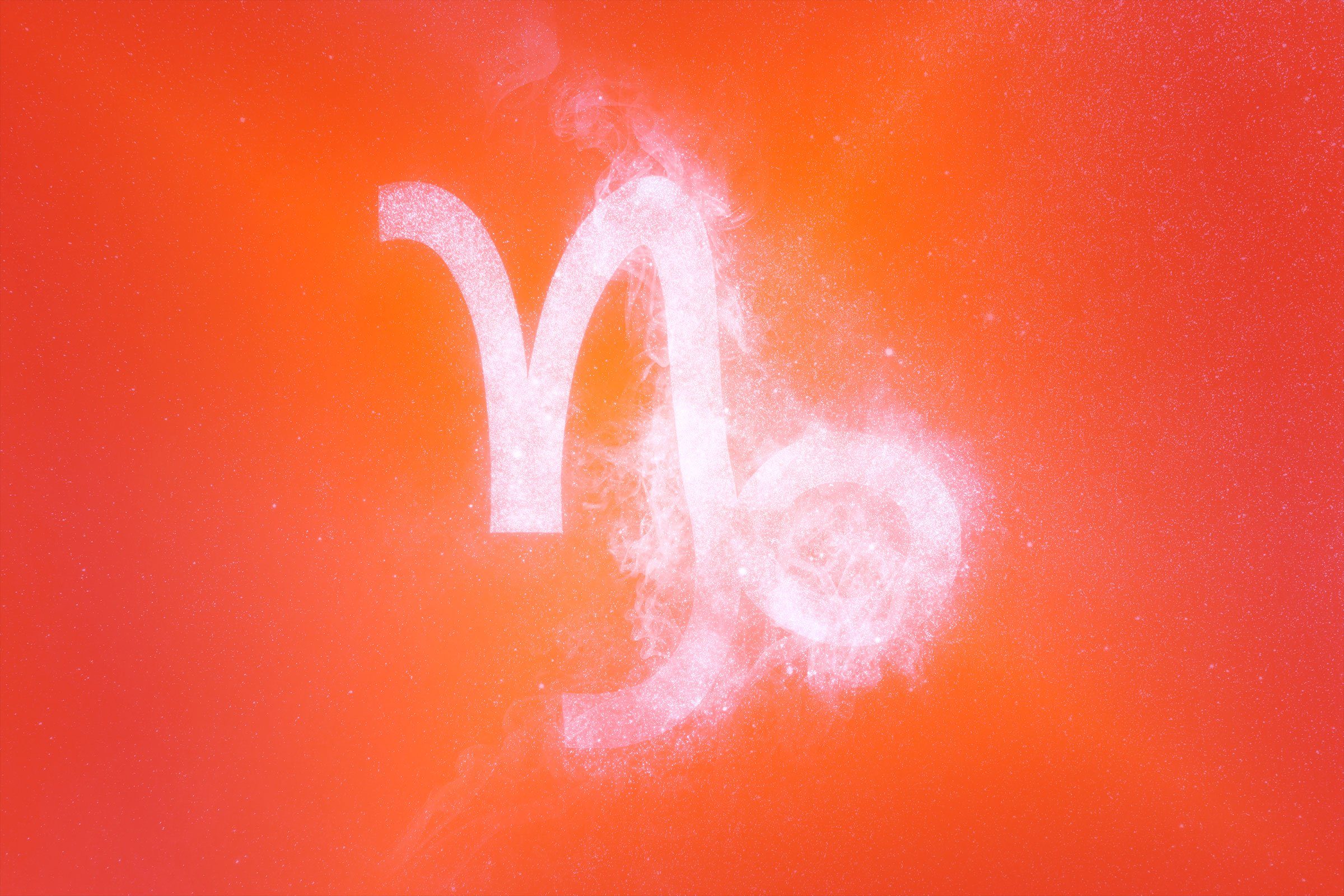 capricorn symbol with red-orange gradient overlay