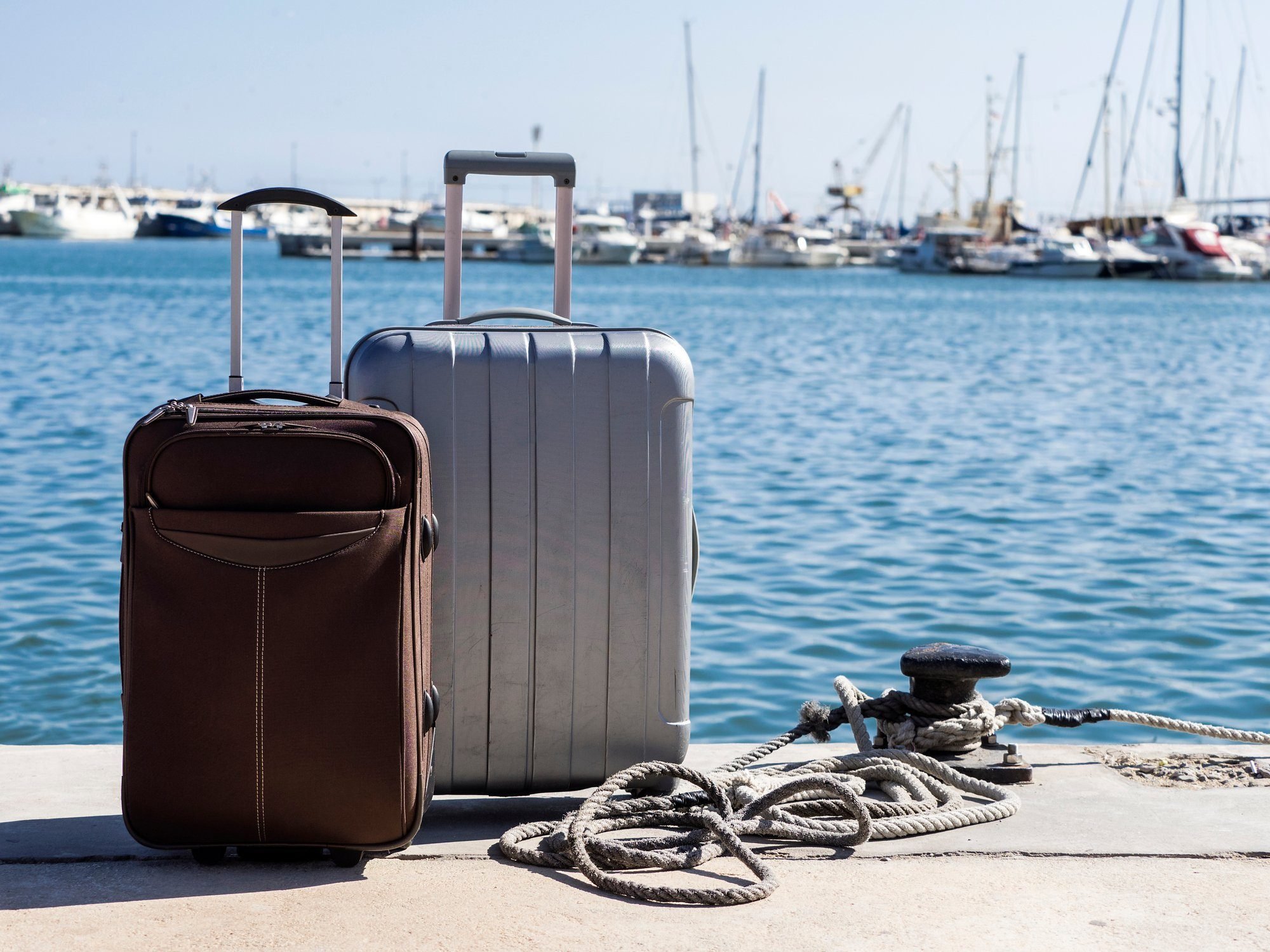 Suitcases prepared next to a pier at sea to board a passenger ship