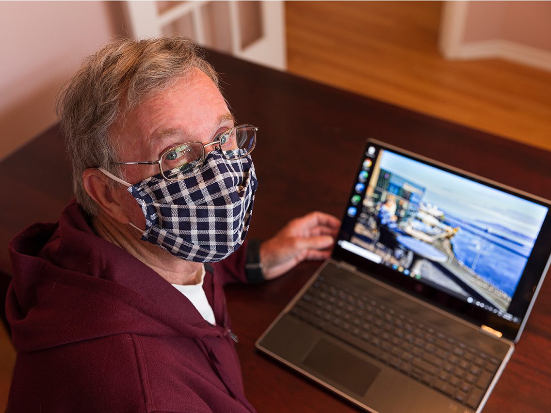 Face mask selfies from across Canada - man in mask with laptop