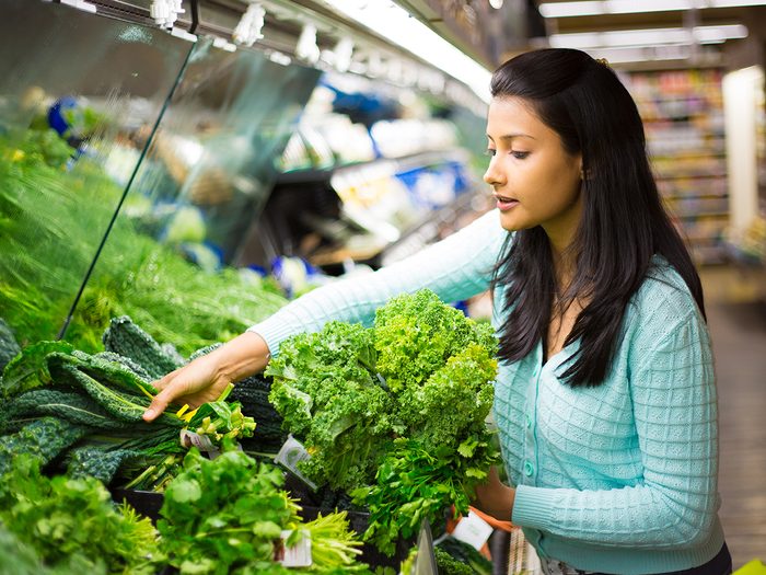 Foods that lower blood pressure - woman shopping for leafy greens