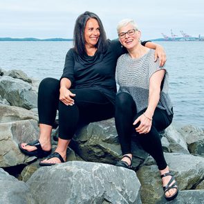 How to make new friends as an adult - friends Susan Goupil and Anne-Marie McElrone sit on a rock.