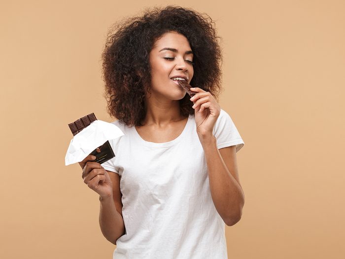 Secrets to a good night's sleep - woman eating chocolate