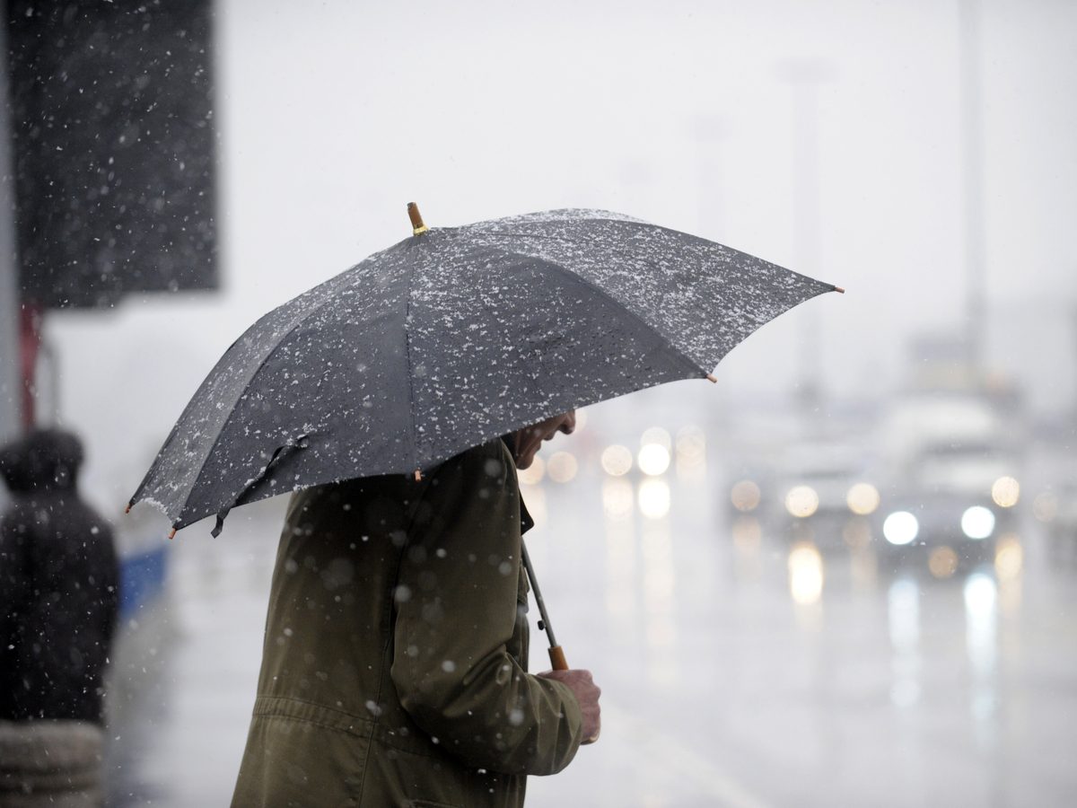 Man holding an umbrella on a rainy day