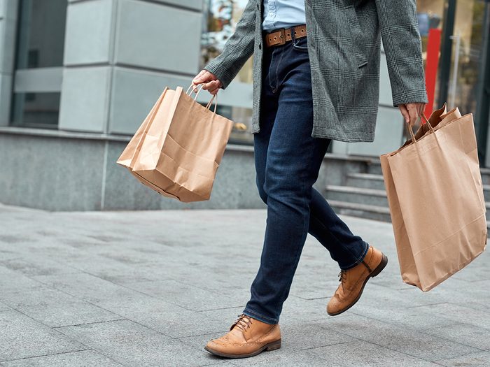 15 money mistakes - man with shopping bags