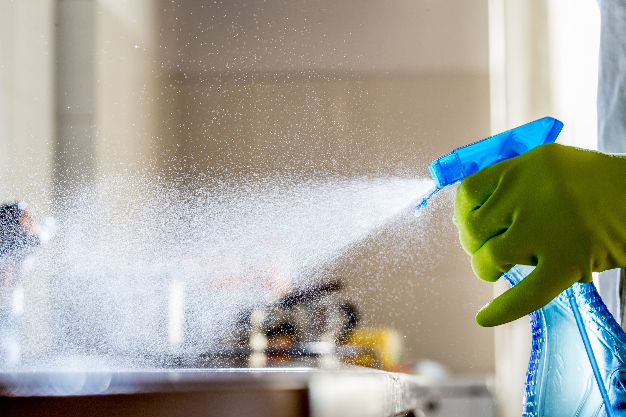 Spraying Cleaning Product on the Kitchen Counter