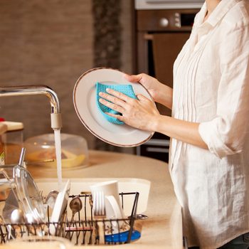 Bad cleaning habits - woman washing dishes