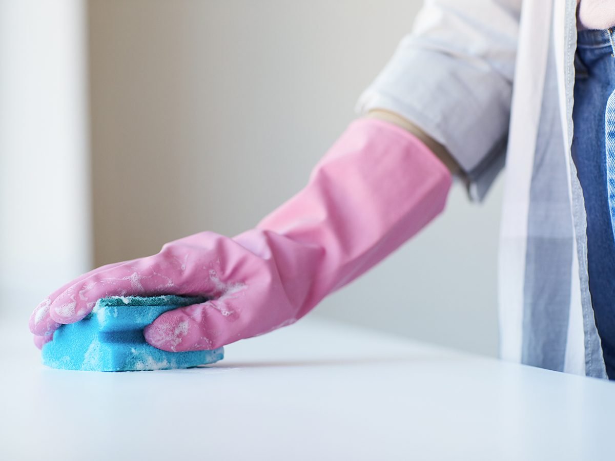 Bad cleaning habits - person wiping surface with sponge