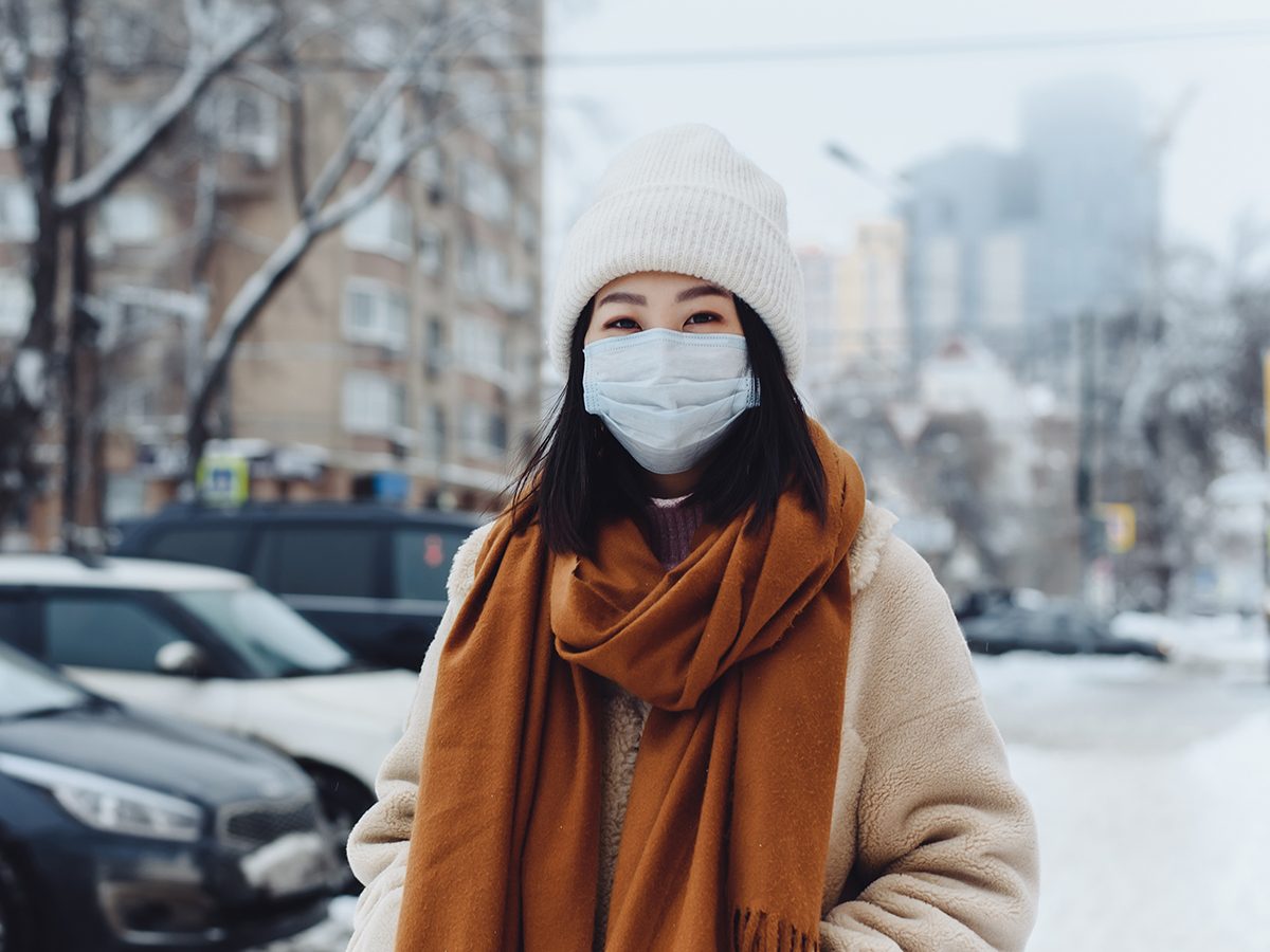 How to prep for COVID-19 this winter - woman wearing mask outside