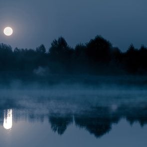 Creepy facts Canada - Night mystical scenery. Full moon over the foggy river and its reflection in the still water.
