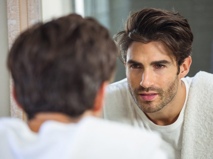 How to improve self confidence - man looking in mirror