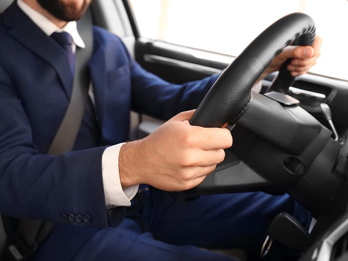 How to reduce car insurance - man in suit driving safely